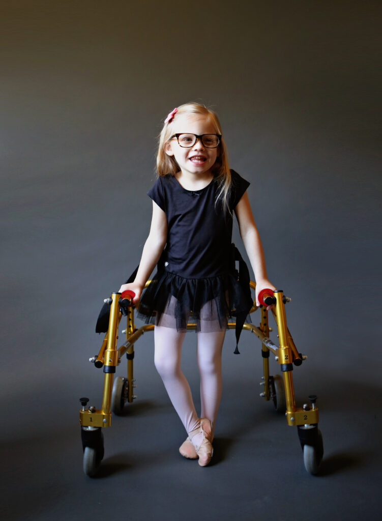 A young girl is able to enjoy the social activity of dancing using her walker.
