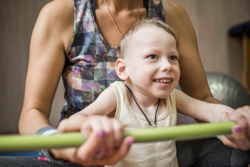 A little boy enjoying a social activity at the gym
